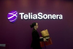 A woman walks past TeliaSonera's logo during the company's fourth quarter result presentation